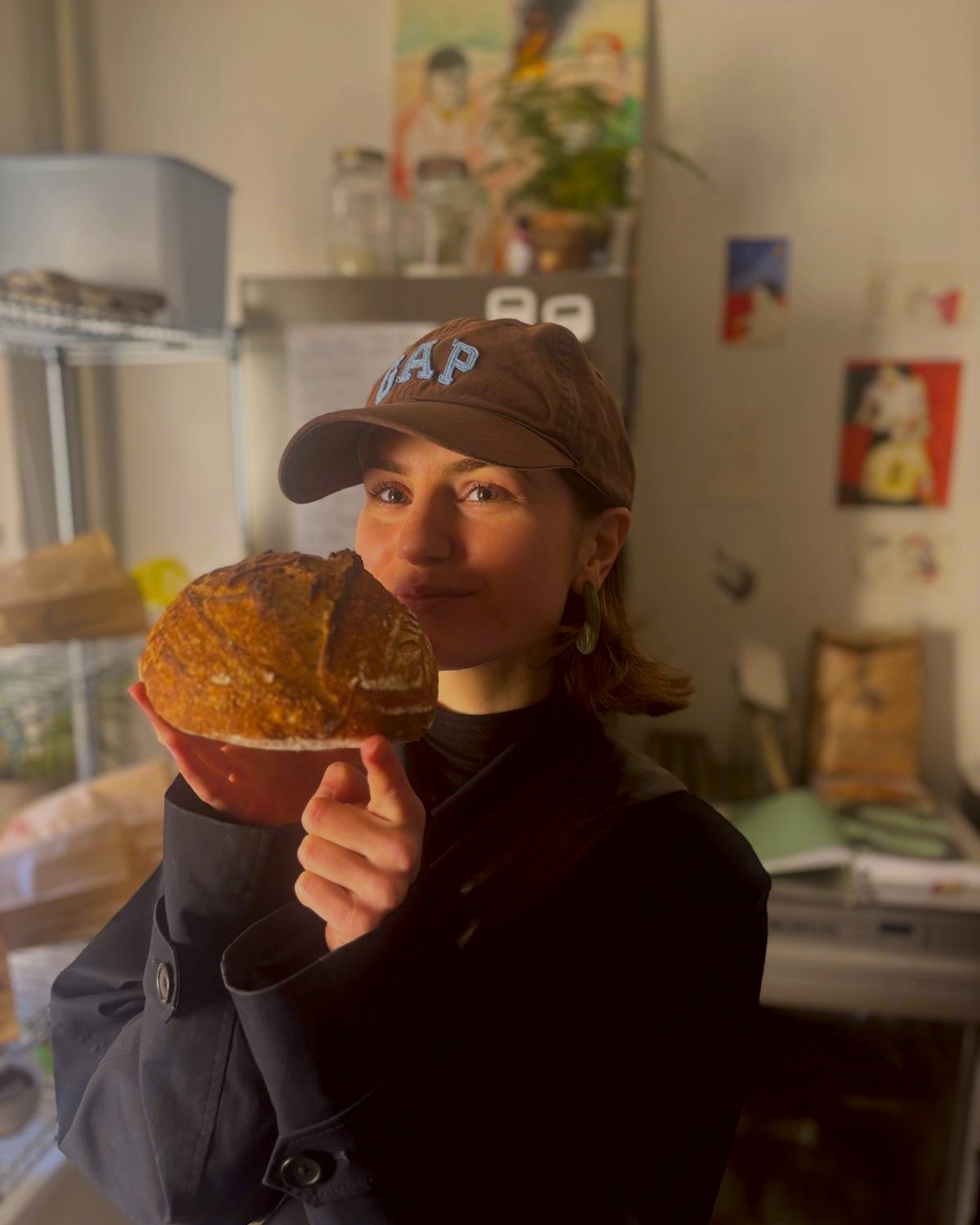 Daan holding a fresh loaf up to her nose, eyes closed